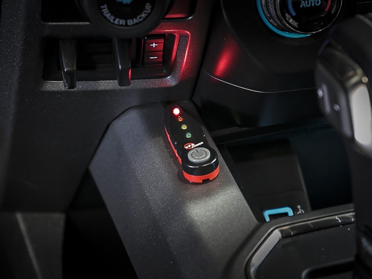 Aftermarket aFe Scorcher GT power module installed inside cabin to alter power with four light-up button modes